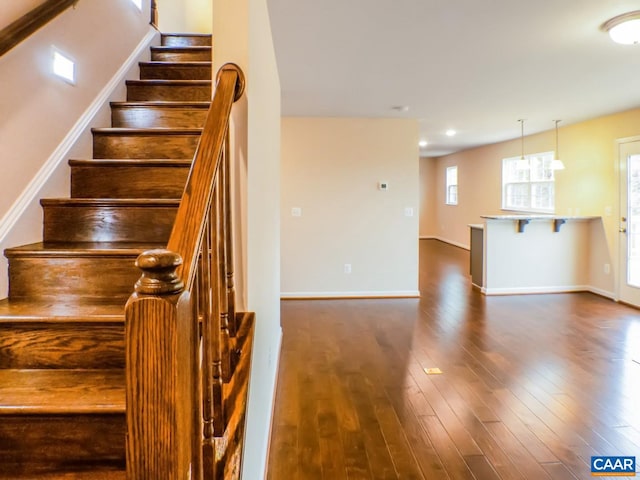 stairs with dark hardwood / wood-style floors