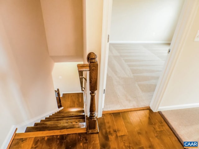 stairway with dark hardwood / wood-style floors