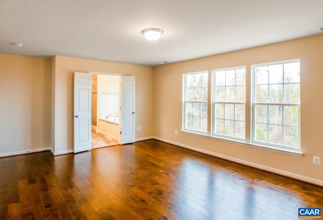 spare room featuring dark hardwood / wood-style floors