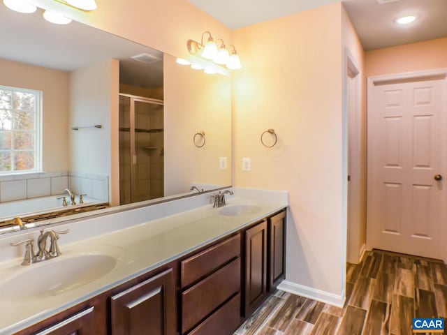 bathroom with double vanity and a bath to relax in