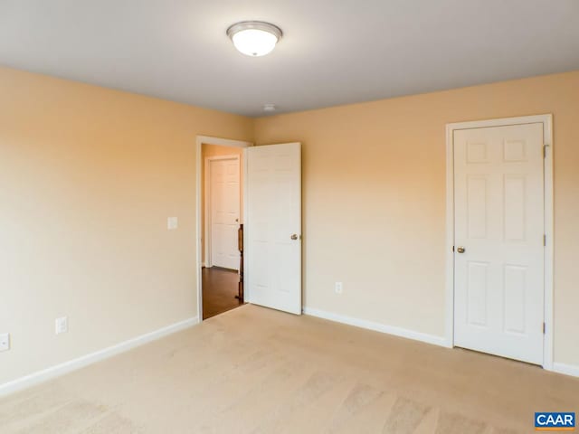 unfurnished bedroom featuring light carpet