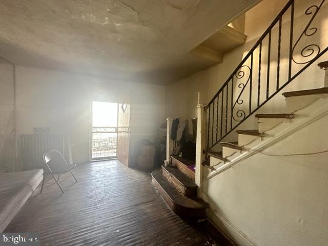 staircase with hardwood / wood-style floors