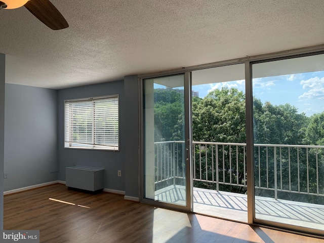 doorway to outside with a healthy amount of sunlight, ceiling fan, and hardwood / wood-style flooring