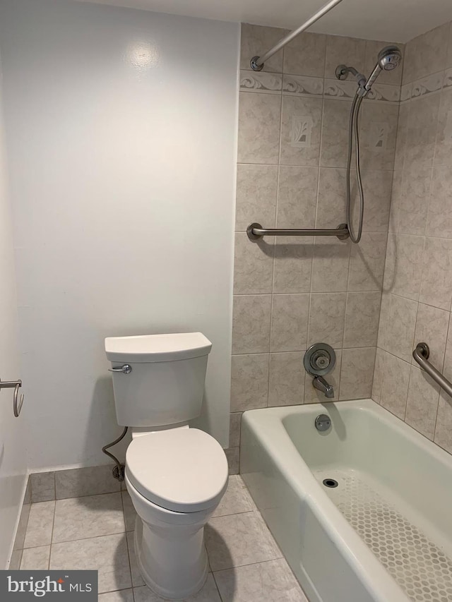 bathroom with tiled shower / bath, toilet, and tile floors