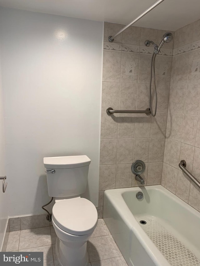 bathroom featuring tile flooring, toilet, and tiled shower / bath