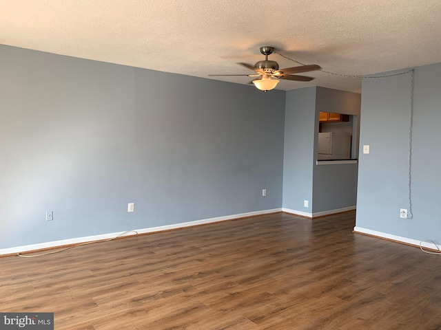 empty room featuring a textured ceiling, dark hardwood / wood-style floors, and ceiling fan