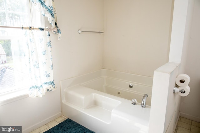 bathroom featuring tile floors and a bath to relax in