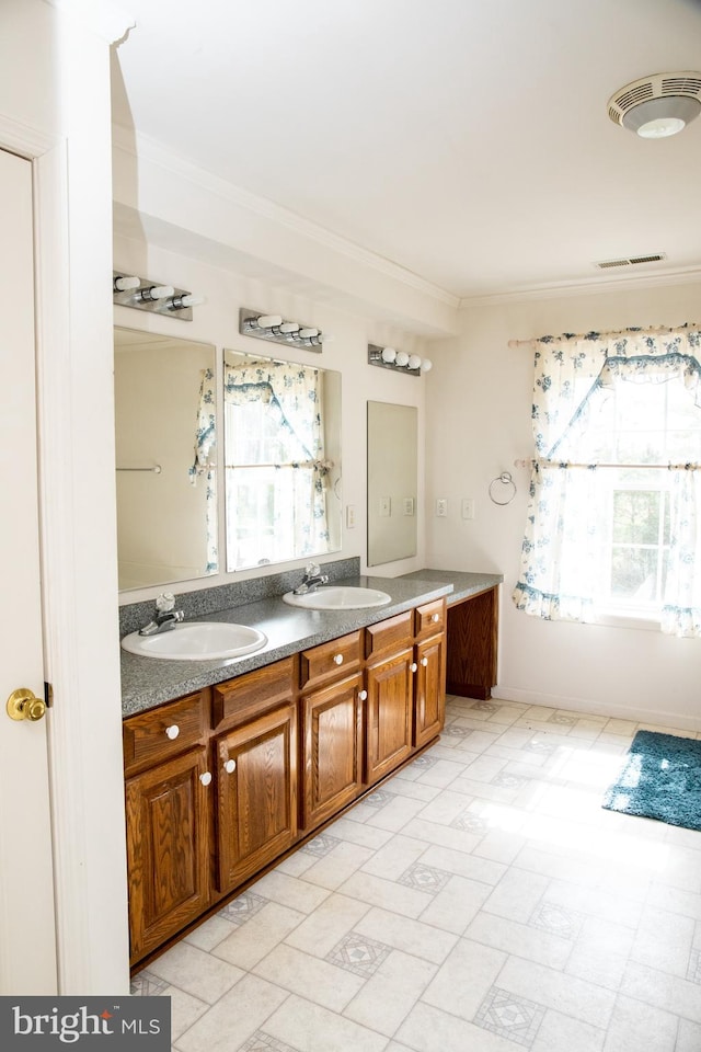 bathroom featuring dual bowl vanity, tile flooring, and a healthy amount of sunlight