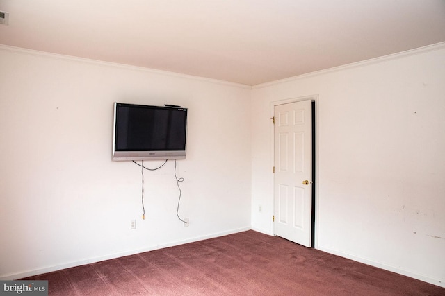 unfurnished room featuring crown molding and dark colored carpet