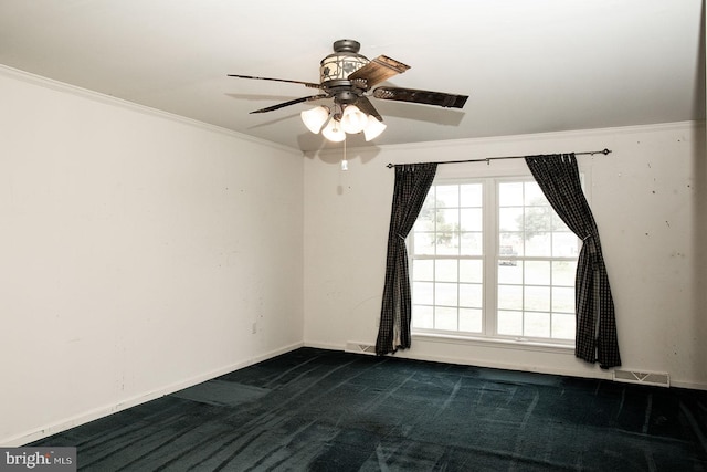 carpeted spare room with ceiling fan and crown molding