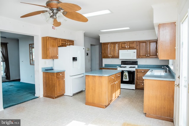 kitchen featuring ceiling fan, white appliances, a kitchen island, and light tile floors