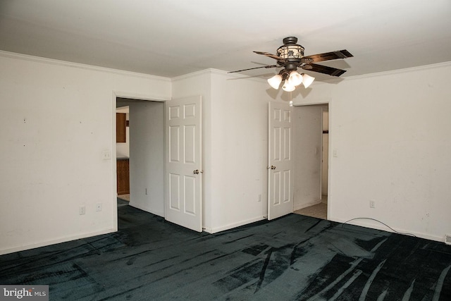 unfurnished bedroom with dark carpet, crown molding, and ceiling fan