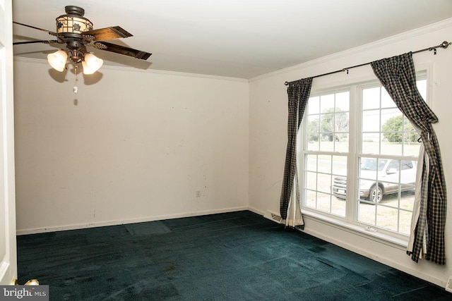 carpeted empty room with ceiling fan and crown molding