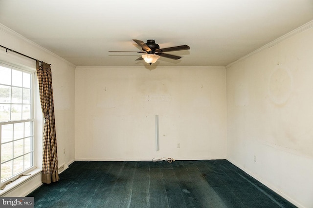 carpeted empty room featuring ceiling fan, ornamental molding, and plenty of natural light