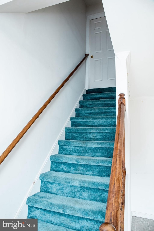 stairway featuring tile floors