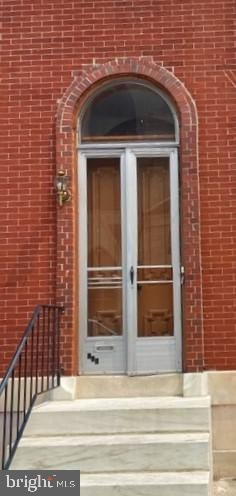 view of exterior entry featuring french doors