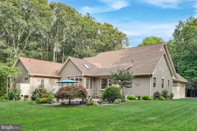 single story home with a front yard and a garage