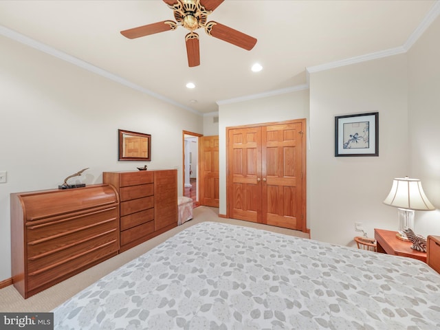 carpeted bedroom featuring a closet, ornamental molding, and ceiling fan