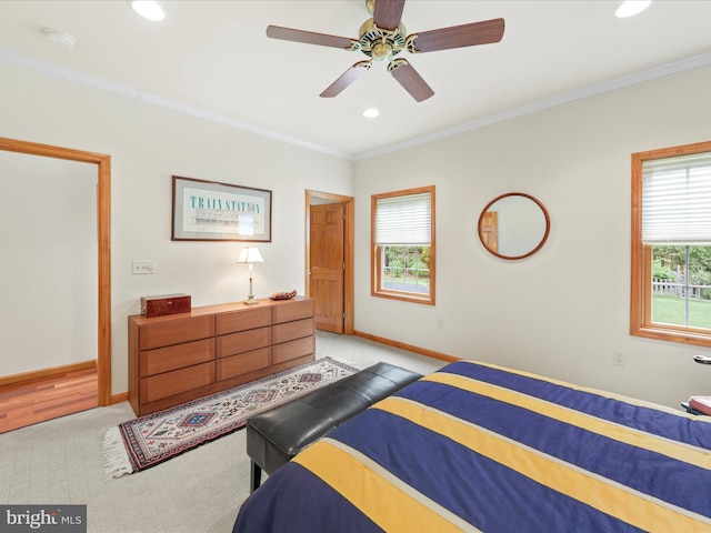 bedroom with crown molding, ceiling fan, and light wood-type flooring