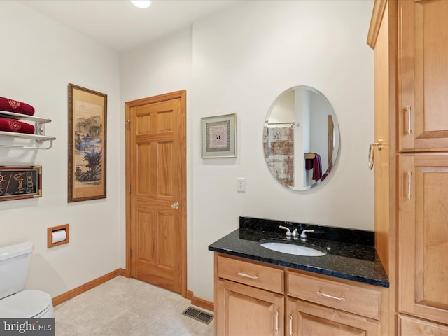 bathroom with vanity, tile flooring, and toilet