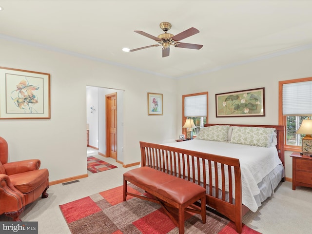 bedroom with light carpet, ceiling fan, and ornamental molding