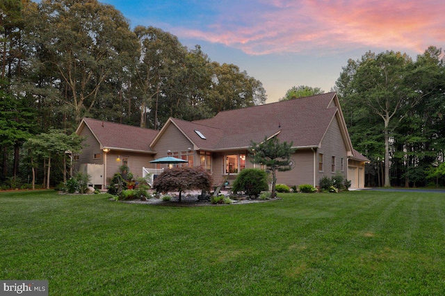 single story home with a lawn and a garage