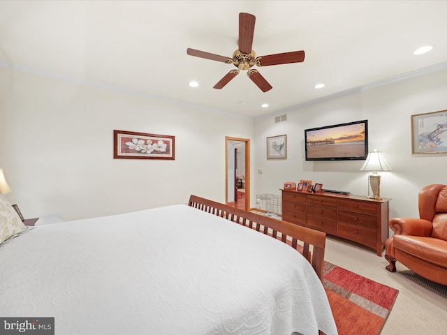 carpeted bedroom with ornamental molding and ceiling fan