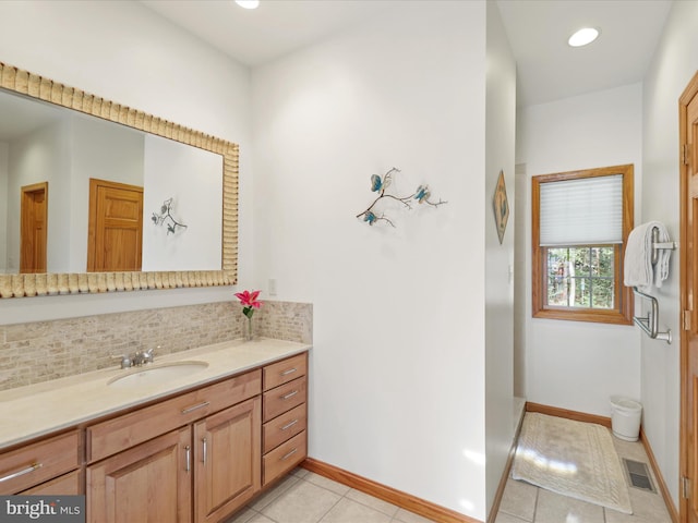 bathroom with vanity, tile flooring, and backsplash