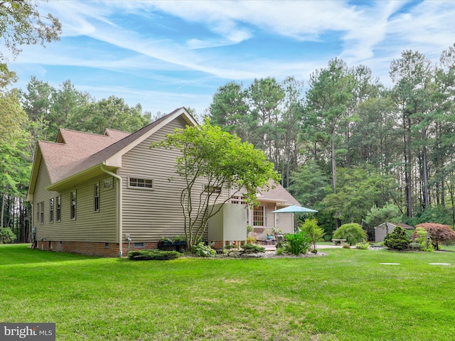 back of property with a patio and a yard