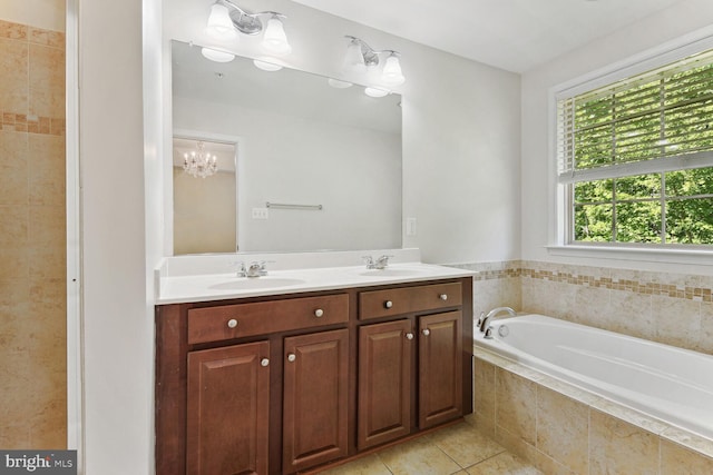 bathroom with dual sinks, oversized vanity, a chandelier, tiled bath, and tile floors