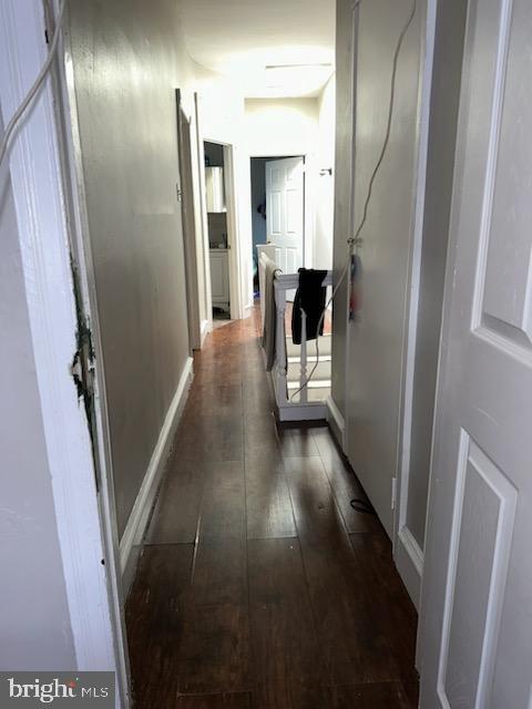 hall with dark hardwood / wood-style flooring