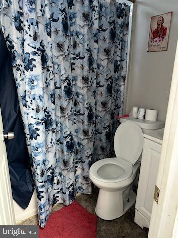 bathroom featuring toilet and vanity