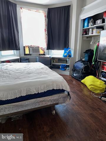 bedroom featuring multiple windows and hardwood / wood-style flooring