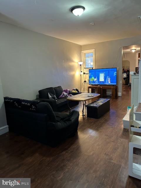 living room with dark hardwood / wood-style floors