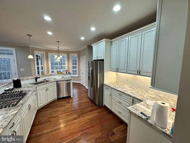 kitchen featuring a sink, appliances with stainless steel finishes, crown molding, decorative backsplash, and dark wood-style flooring