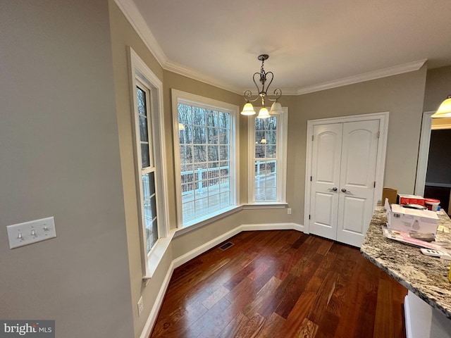 unfurnished dining area with dark wood-style floors, visible vents, crown molding, and baseboards