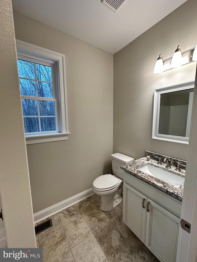 bathroom with visible vents, baseboards, toilet, and vanity