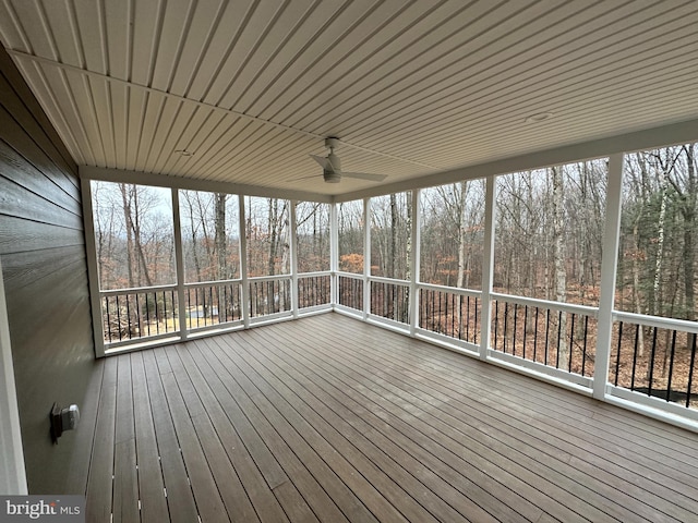 unfurnished sunroom with ceiling fan