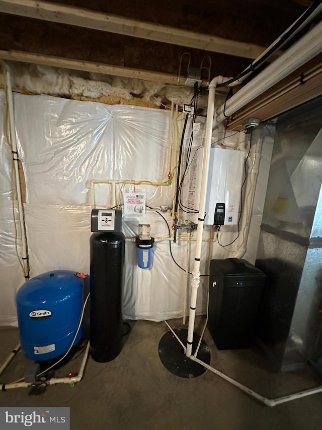 utility room featuring tankless water heater