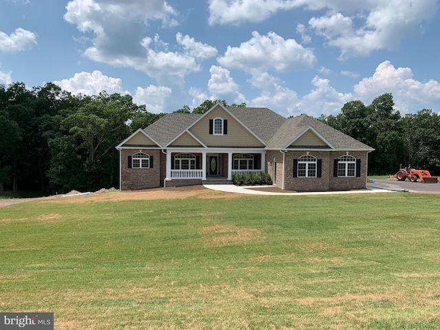 craftsman inspired home with a front yard and a porch