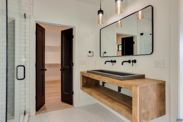 bathroom featuring vanity, tile floors, and a shower with door