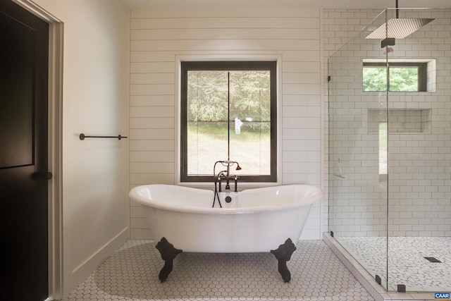 bathroom featuring tile flooring and shower with separate bathtub