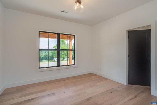 unfurnished room with light hardwood / wood-style floors