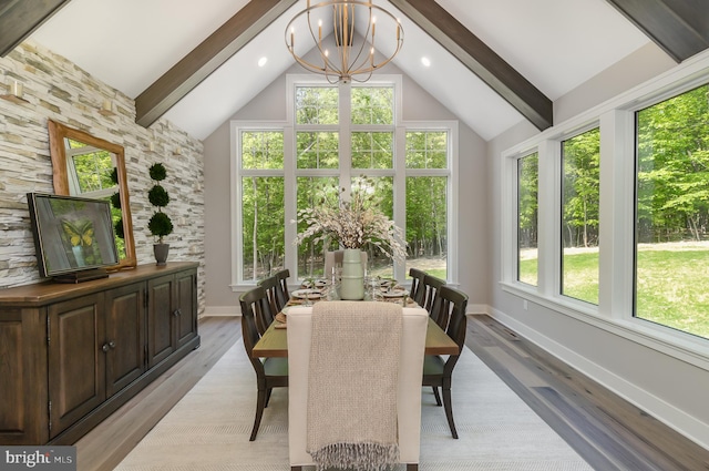 sunroom with vaulted ceiling with beams, a chandelier, and a healthy amount of sunlight