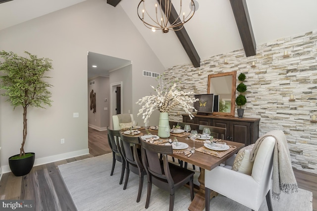 dining room with a notable chandelier, dark hardwood / wood-style floors, beam ceiling, and high vaulted ceiling