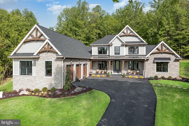 view of front of property with covered porch and a front lawn