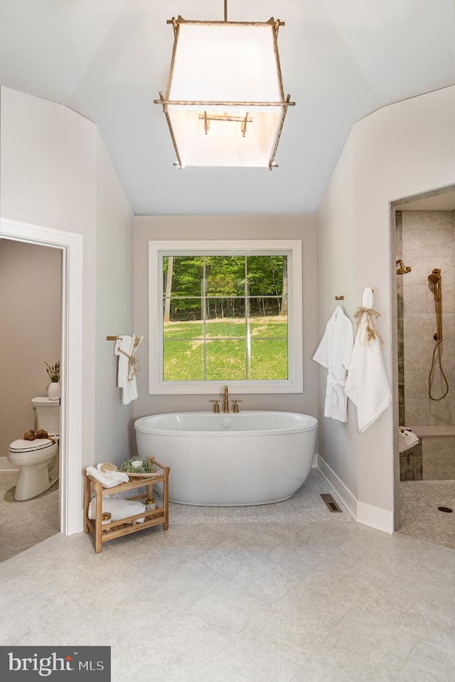 bathroom with tile flooring, toilet, separate shower and tub, and lofted ceiling