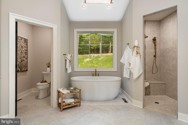 bathroom with toilet, tile floors, and tiled shower