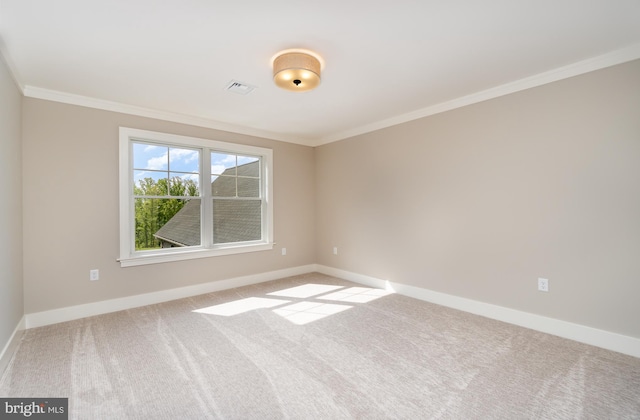 unfurnished room with ornamental molding and light carpet