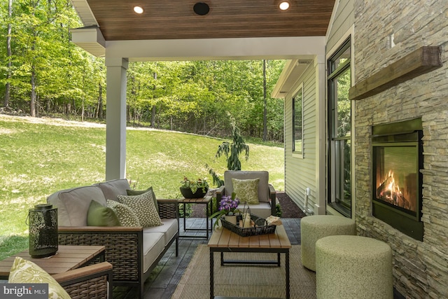 view of patio featuring an outdoor living space with a fireplace